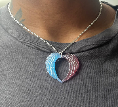 closeup shot of angel wing heart necklace being modeled